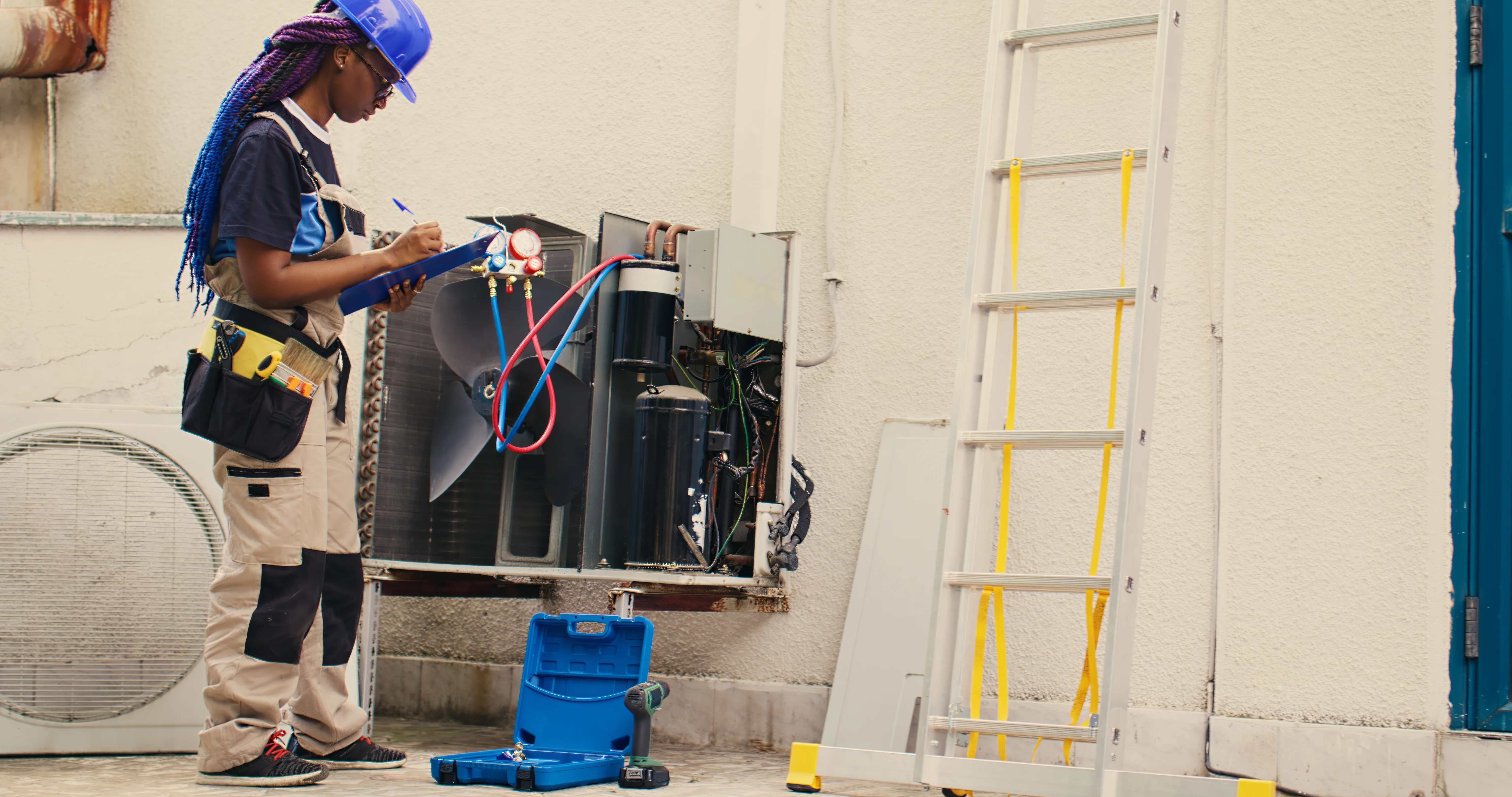 Technician repairing split AC unit